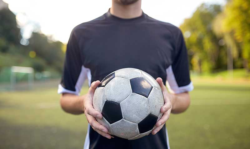 man holding soccer ball- sound fc